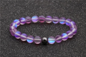 Iridescent purple moonstone beaded bracelet with black hematite accent on glittery background