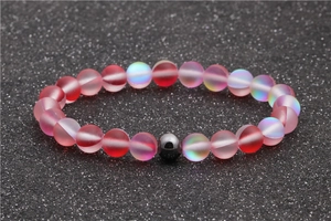 Beaded moonstone and hematite bracelet with matte pink gradient beads on a grey background