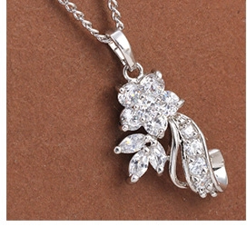 Macro detail of silver flower necklace pendant with sparkling zirconia stones