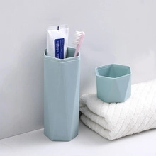 Detail of light blue hexagonal travel toothbrush case with matte finish and toiletries