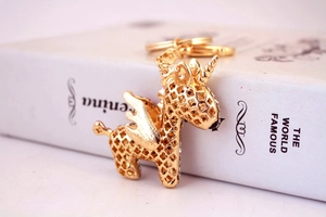 Detail of a golden unicorn keychain with crystal rhinestones and hollow wings