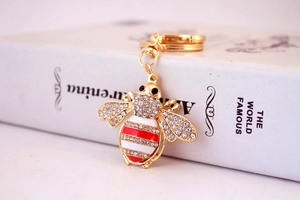 Detail of crystal bee keychain with red enamel and gold-plated D-ring clasp