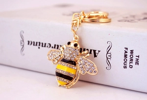 Detailed close-up of crystal bee keychain with gold alloy finish and enamel texture