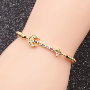 Adjustable gold star and moon bracelet with multicolored zircon stones on wrist