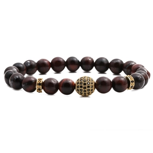 Tiger eye beaded cross bracelet with red-brown beads and gold-plated accents on white background
