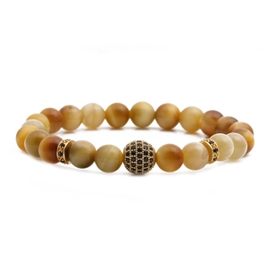 Tiger eye beaded bracelet featuring a black zircon ball and gold spacers on white background