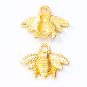Pair of vintage golden alloy bee charms with detailed wings and stripes for DIY jewelry