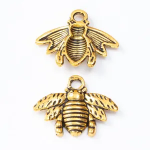 Pair of vintage gold bee alloy charms for DIY jewelry making with antique finish