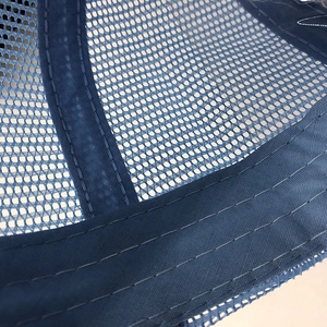 Detailed macro view of blue mesh fabric and reinforced stitching for breathable sun hat
