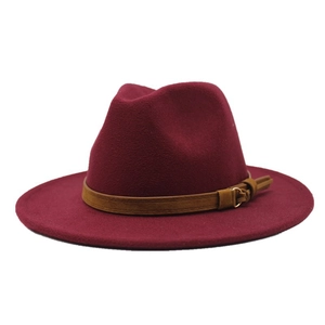 Close-up of burgundy wool fedora hat with a classic brown faux leather belt buckle