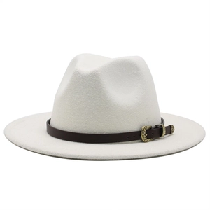 Detail of white wool fedora hat featuring a brown leather band and gold snake buckle