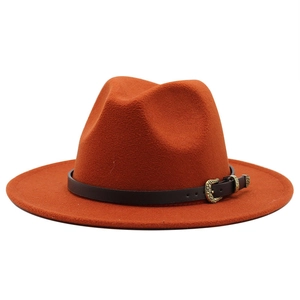 Detailed shot of orange wool fedora with brown leather belt and golden vintage buckle