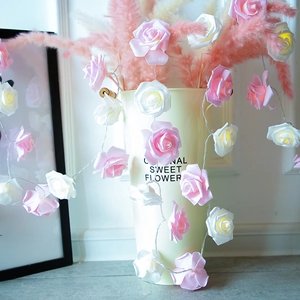 Pink and white LED rose flower string lights on a vase for elegant home decor