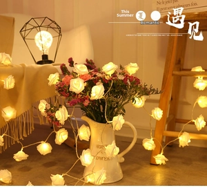 Close-up of warm yellow LED rose string lights for romantic home and wedding decor