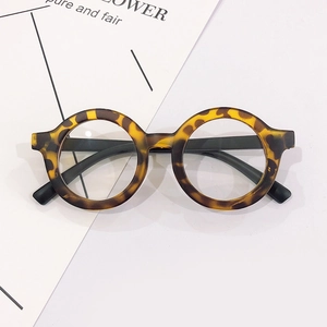 Classic round kids tortoise shell frame glasses with black temples on white background