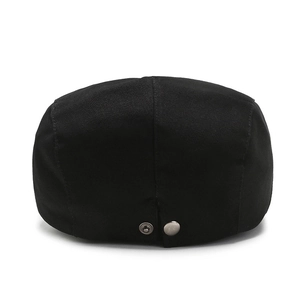 Rear view of black cotton newsboy cap with adjustable silver metal buckles on white background