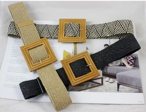 Macro shot of three bohemian woven elastic belts with square buckles on an open magazine