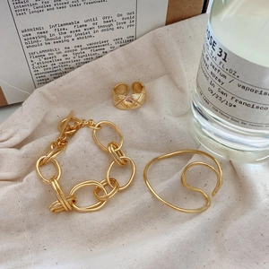 French vintage style gold quilted ring and bracelet set on linen texture fabric