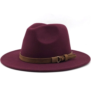 Detail of burgundy wool fedora hat featuring brown leather band and gold metal buckle