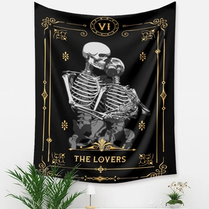 Detail shot of The Lovers tarot tapestry showing black fabric with golden sun and bone motifs