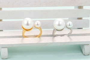Minimalist adjustable open rings with faux pearls in gold and silver finish on display