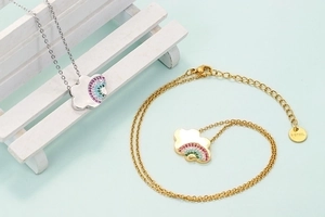 Rainbow cloud pendant necklace in gold and silver stainless steel on creative background