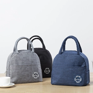 Detailed view of insulated lunch bags in grey, black and blue with round panda patches