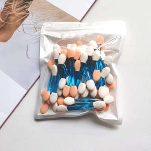Detail of bulk double-sided sponge eyeshadow applicators in a transparent poly bag