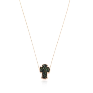 Cross necklace with rose gold frame and sparkling dark green inlay on white background