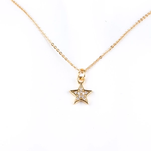 Detailed view of a gold plated brass star pendant necklace with micro-pave zircons
