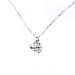 Macro view of silver elephant pendant with micro-set zircon stones on white background