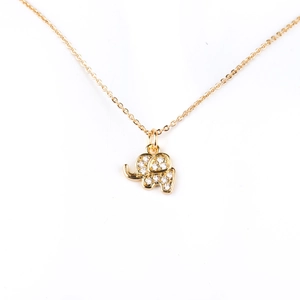 Detailed close-up of a golden elephant pendant with micro-inlaid clear zircon stones