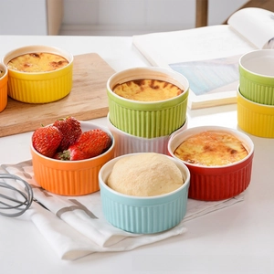 Close-up of heart-shaped ceramic ramekins with vertical embossed stripes for baking