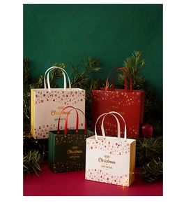 Detail of assorted Christmas paper gift bags with festive pine and gold lettering