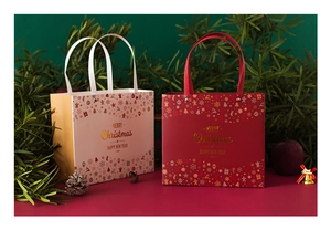 Red and white Christmas gift bags with gold Merry Christmas lettering and pine decorations