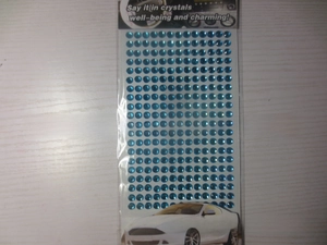 Close-up of self-adhesive blue acrylic round rhinestone stickers for DIY crafting