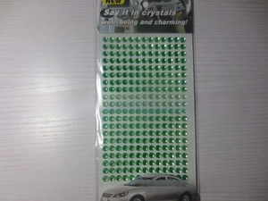 Macro view of 3mm emerald green self-adhesive acrylic rhinestone stickers for DIY car decor