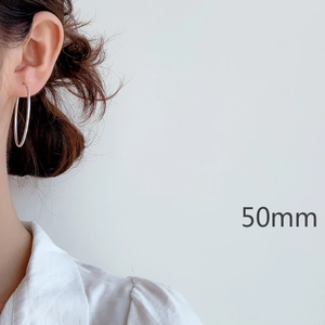 Minimalist s925 sterling silver 50mm large hoop earrings worn by a model