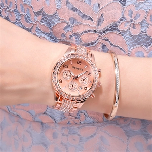 Detailed view of rose gold crystal watch and matching diamond bracelet on a woman wrist