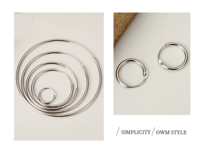 Macro detail of various sizes S925 sterling silver hoop earrings with secure clasp mechanism