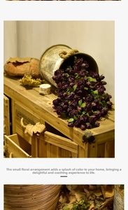 Artistic layout of vintage purple silk roses cascading over a rustic wooden drawer cabinet