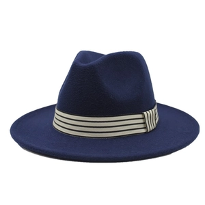 Detail of dark blue wool fedora hat with a striped cream ribbon and flat brim
