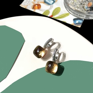 Macro detail of amber square cut crystal earrings with micro-pave diamond setting