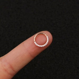 Macro shot of rose gold stainless steel ring inlaid with clear cubic zirconia crystals