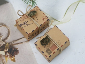 Close-up of vintage kraft paper candy boxes with hemp rope and metal globe charms