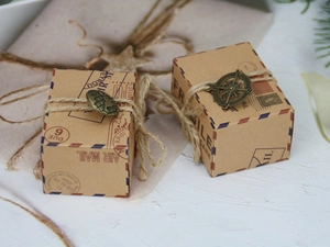 Macro detail of vintage air mail kraft candy boxes with twine and metal globe charms