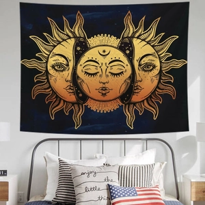 Detail of bohemian sun and moon tapestry hanging above a bed in a modern bedroom