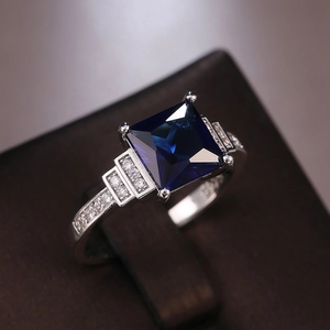 Detailed macro view of Art Deco ring with square blue gemstone and stepped side stones