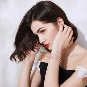 Elegant gold finish brass bracelet with clear cubic zirconia on a female model wrist