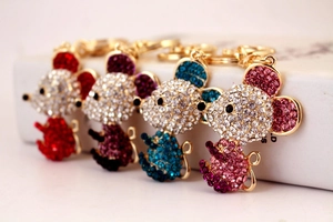 Detailed view of four colorful rhinestone mouse keychains in red, purple, blue and pink